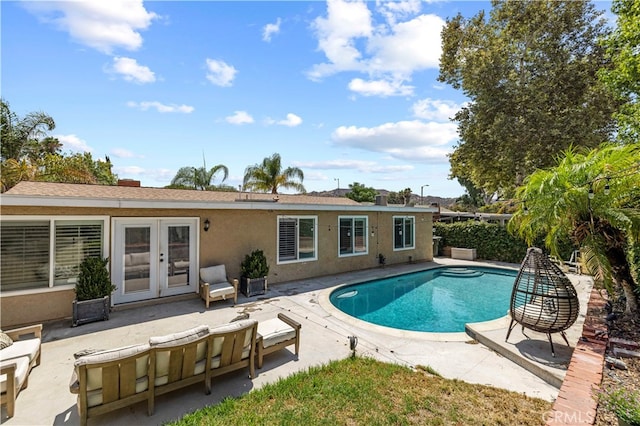 view of swimming pool with a patio and french doors