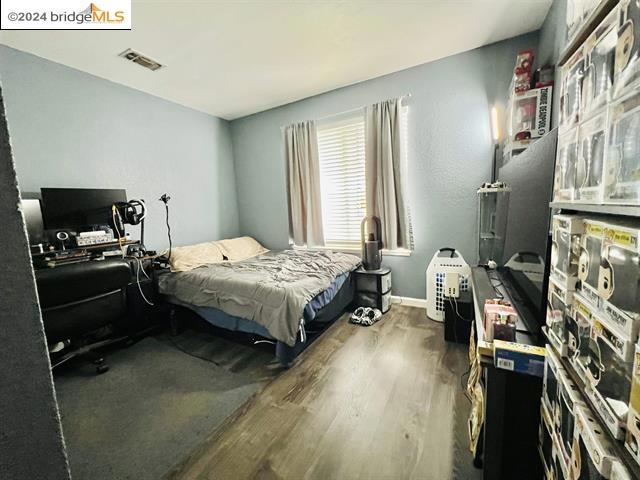 bedroom featuring hardwood / wood-style flooring