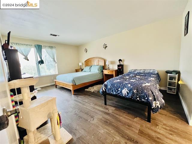 bedroom with wood-type flooring