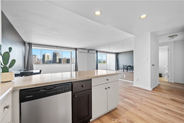 kitchen featuring dishwasher, light wood-type flooring, and white cabinets