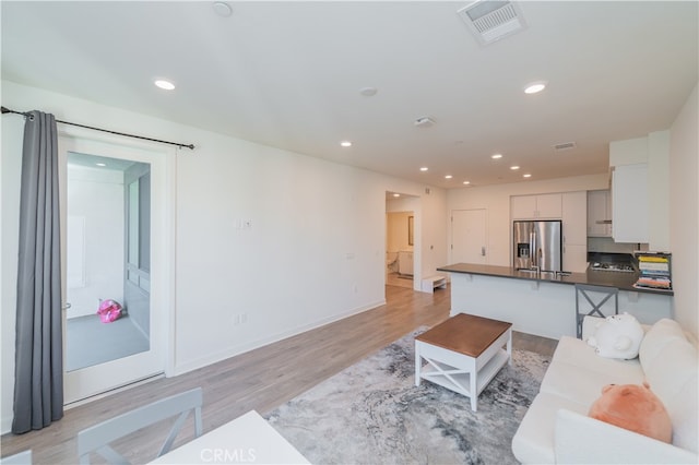 living room featuring light wood-type flooring and sink