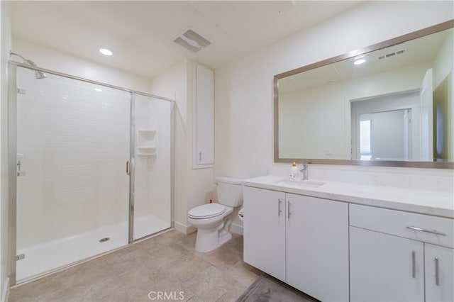 bathroom featuring walk in shower, vanity, and toilet