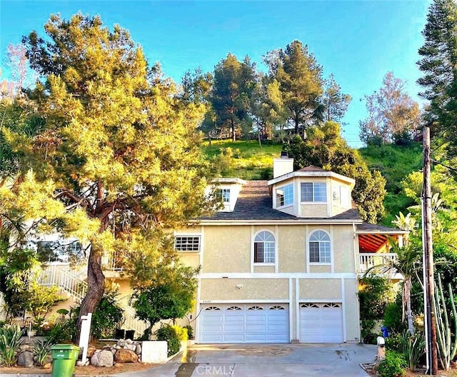 view of front facade with a balcony and a garage