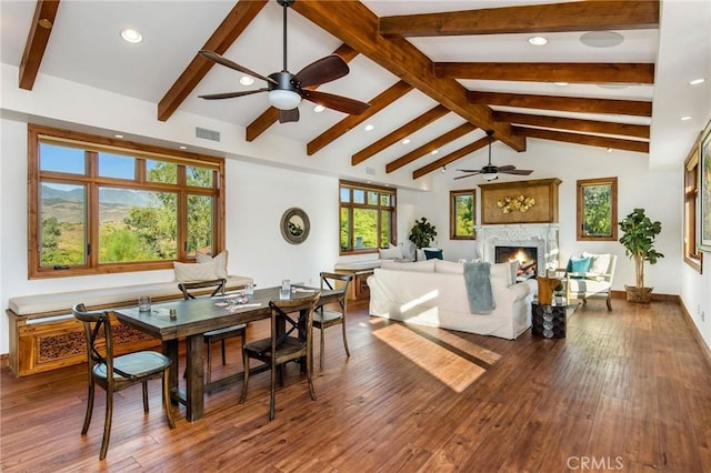 dining space featuring ceiling fan, hardwood / wood-style floors, and lofted ceiling with beams