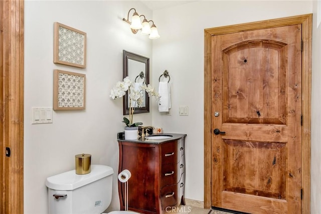 bathroom with toilet and vanity