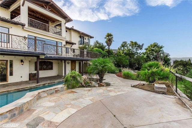 exterior space featuring a balcony and a patio area