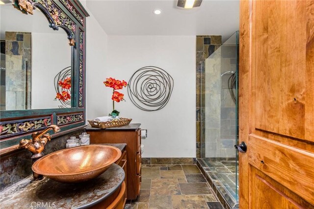 bathroom featuring vanity and a tile shower