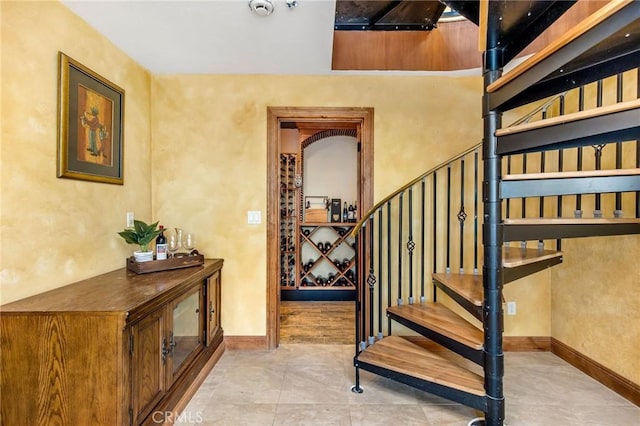 stairway with tile patterned flooring