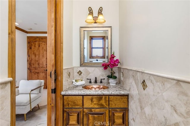 bathroom with tile walls, vanity, and ornamental molding