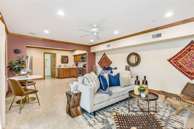 living room with ceiling fan and ornamental molding