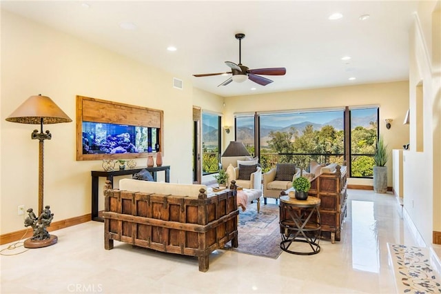 living room featuring ceiling fan and light tile patterned floors