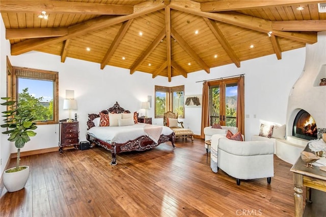 bedroom featuring beamed ceiling, a fireplace, high vaulted ceiling, hardwood / wood-style flooring, and wooden ceiling