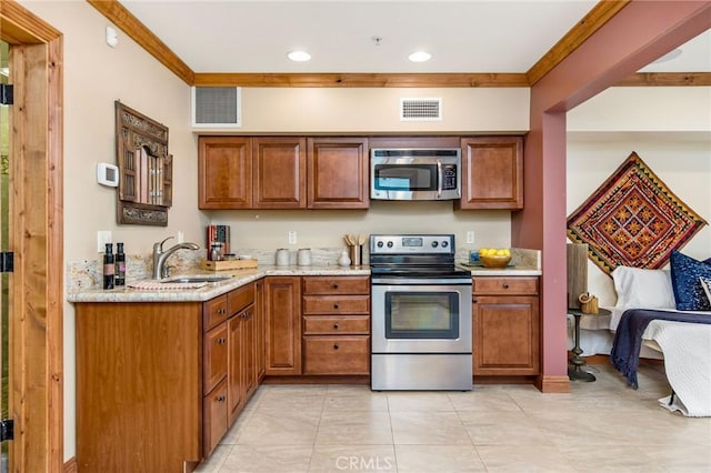 kitchen featuring crown molding, sink, light tile patterned floors, light stone countertops, and stainless steel appliances