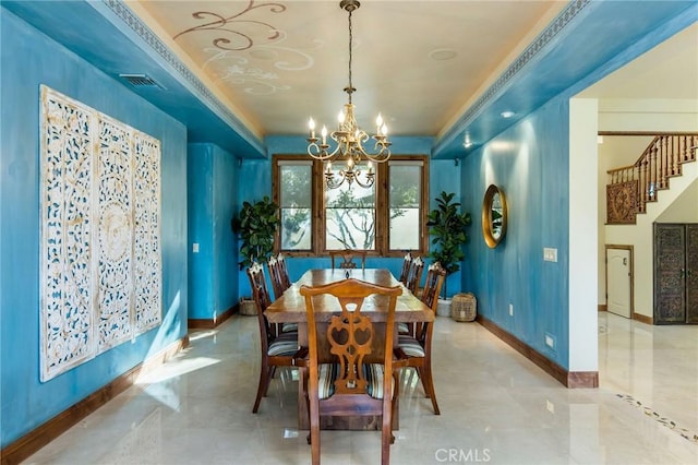 dining area featuring a notable chandelier, a raised ceiling, and ornamental molding