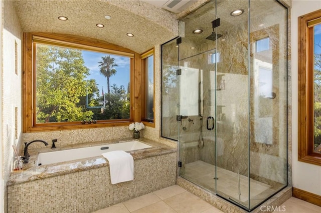 full bathroom with a bath, tile patterned flooring, and a shower stall