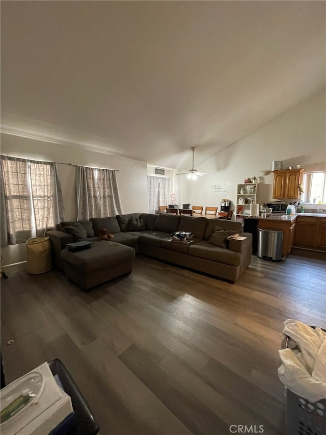 living room with lofted ceiling, dark hardwood / wood-style flooring, and ceiling fan