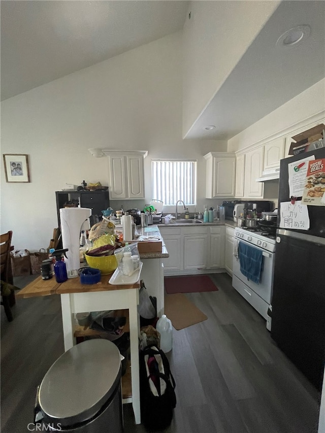 kitchen featuring sink, black refrigerator, white gas range, white cabinetry, and dark hardwood / wood-style flooring