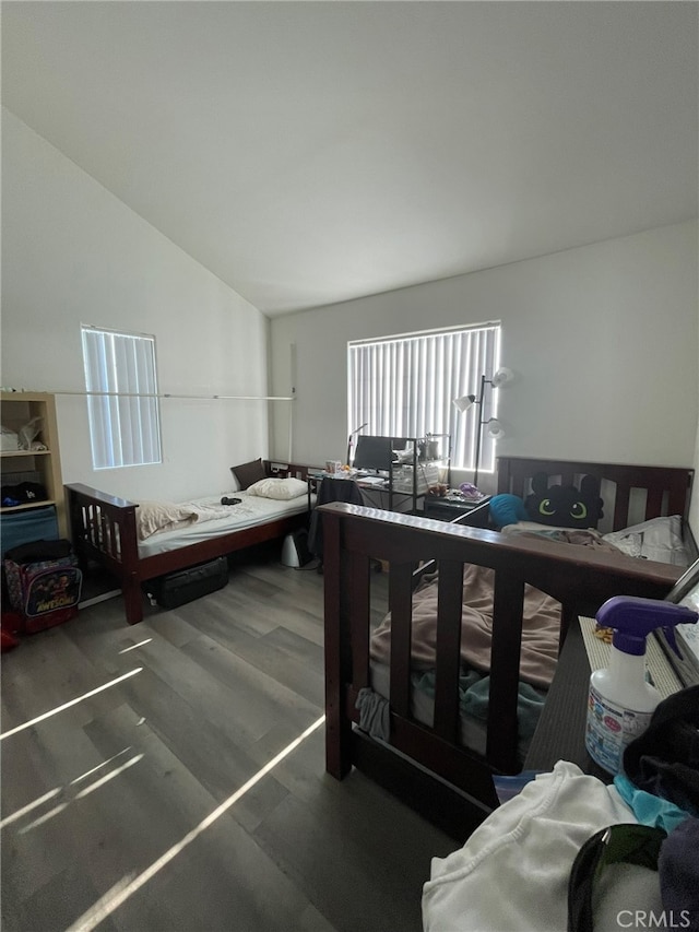 bedroom featuring lofted ceiling and dark wood-type flooring