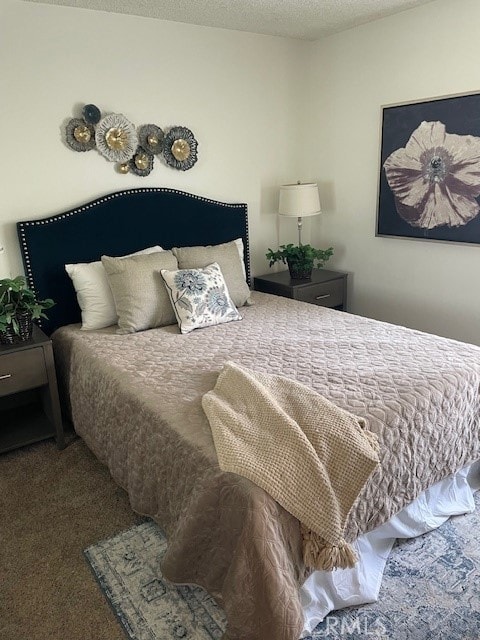 carpeted bedroom with a textured ceiling