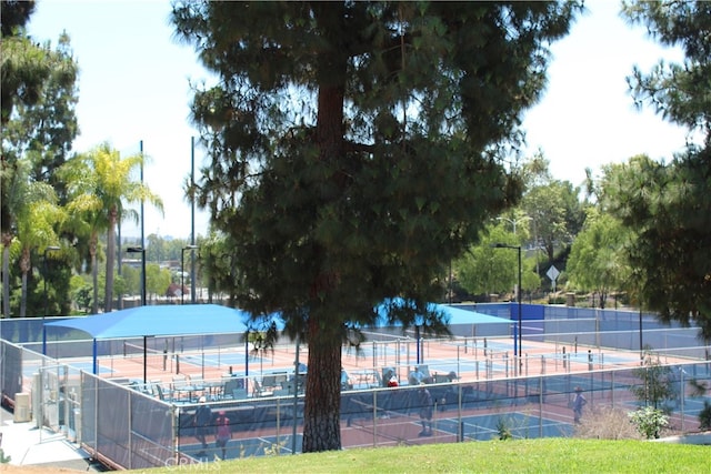 view of swimming pool featuring tennis court