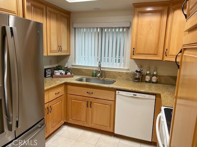 kitchen with white appliances, sink, and light tile patterned floors