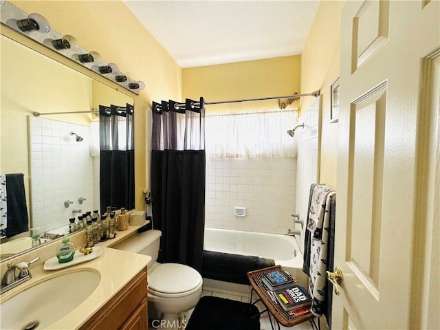 full bathroom featuring toilet, vanity, and shower / tub combo with curtain