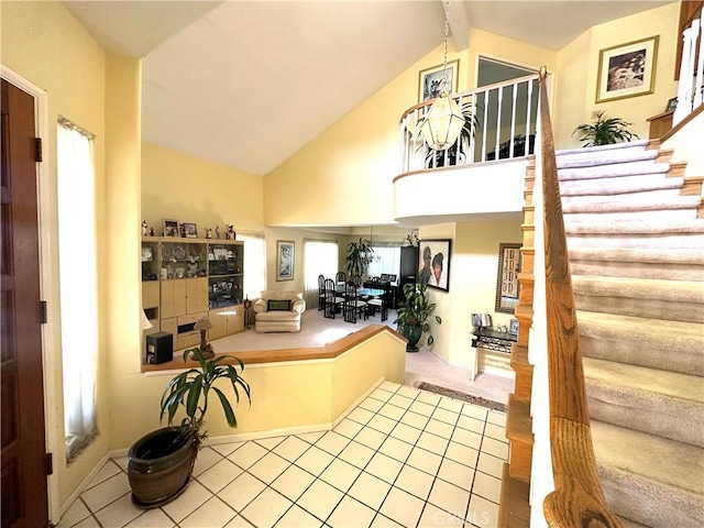 foyer featuring vaulted ceiling with beams and light wood-type flooring