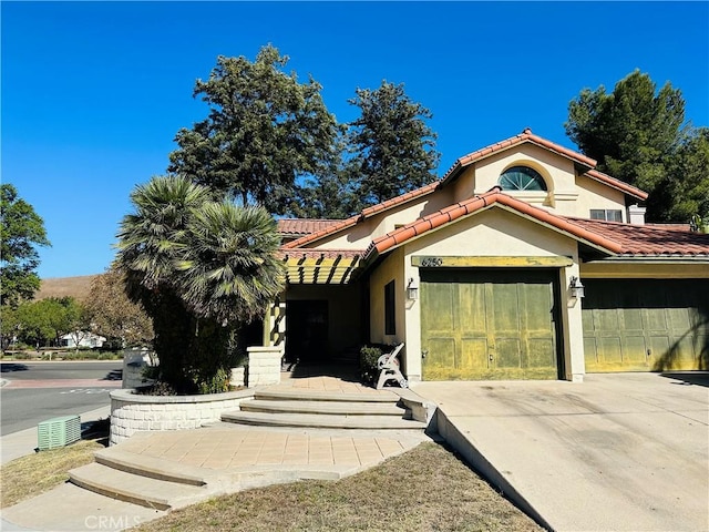 mediterranean / spanish home with a garage