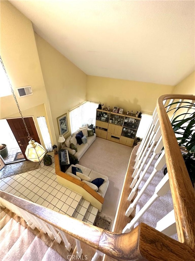 living room featuring carpet floors and high vaulted ceiling