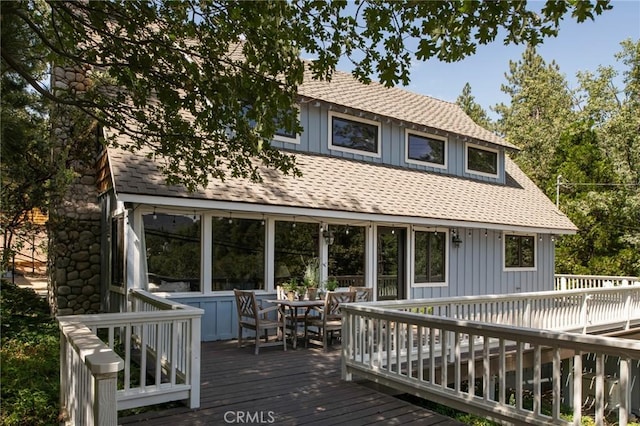 back of house with a wooden deck