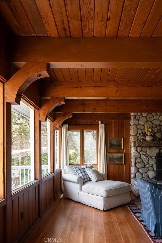 unfurnished sunroom with beam ceiling and wood ceiling