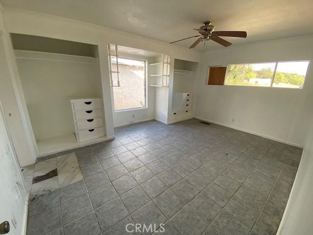 unfurnished bedroom featuring ceiling fan and multiple windows