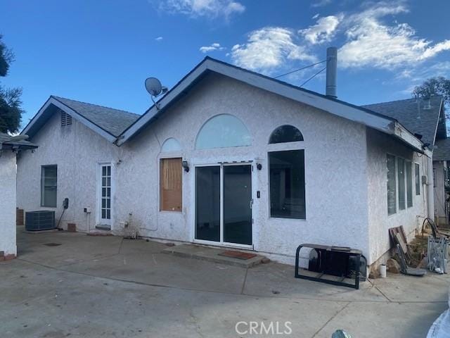 back of house featuring a patio area and cooling unit