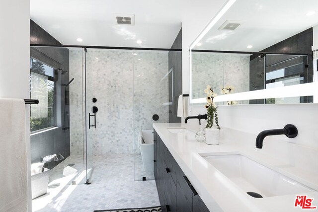 bathroom with tile patterned flooring, vanity, and independent shower and bath