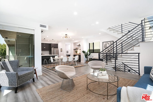 living room with hardwood / wood-style flooring and a chandelier