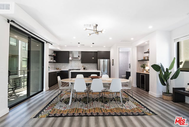 dining area featuring light hardwood / wood-style floors and an inviting chandelier