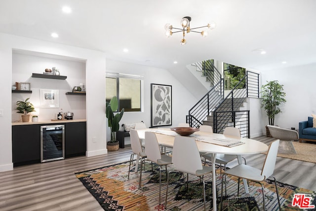 dining area with wine cooler, hardwood / wood-style floors, and a chandelier