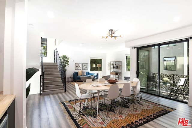 dining room featuring hardwood / wood-style floors and a chandelier