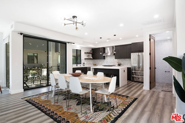 dining area featuring a notable chandelier, light hardwood / wood-style floors, and sink