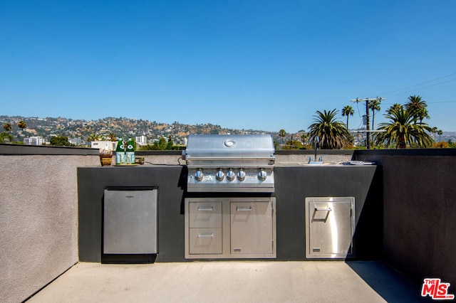 view of patio with sink, area for grilling, and exterior kitchen