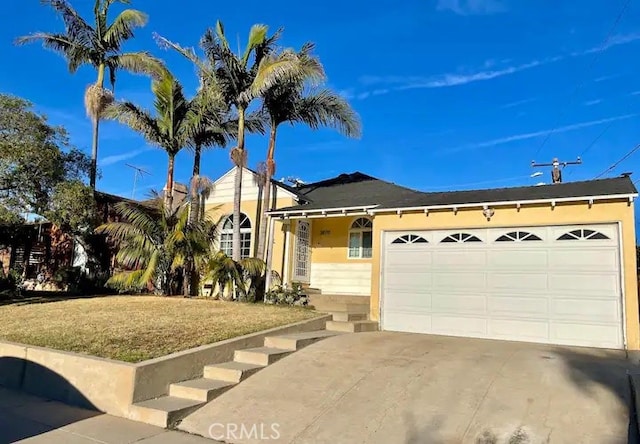 ranch-style home featuring a front yard and a garage