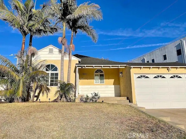 view of front facade with a garage and a front lawn