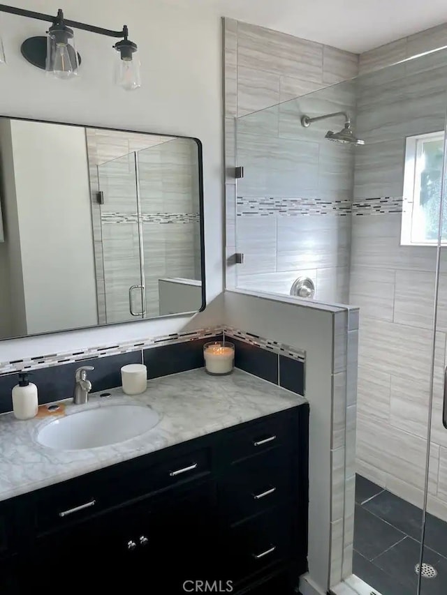 bathroom featuring an enclosed shower and vanity