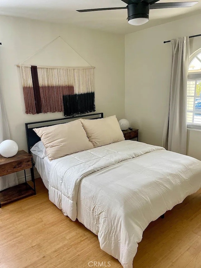 bedroom with ceiling fan and hardwood / wood-style flooring