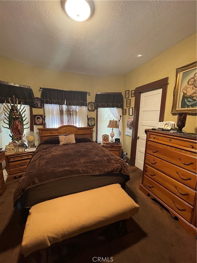 carpeted bedroom featuring a textured ceiling