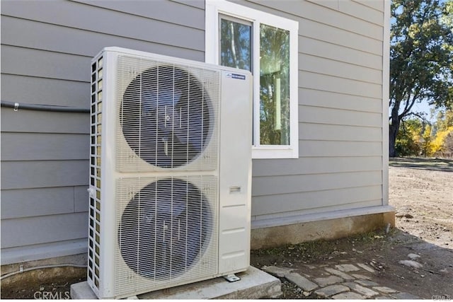 exterior details featuring ac unit and wood walls