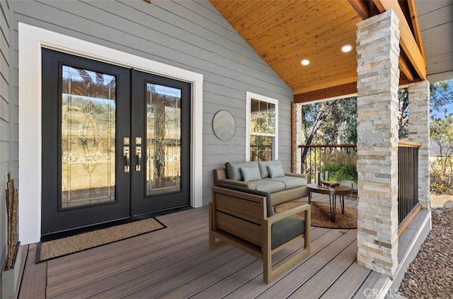 wooden deck with french doors and an outdoor living space