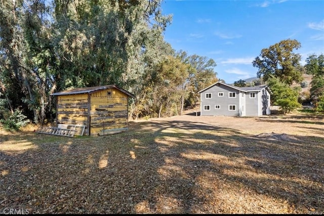 exterior space featuring a shed and an outbuilding