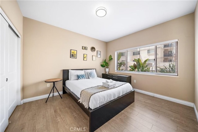 bedroom featuring a closet and light wood-type flooring