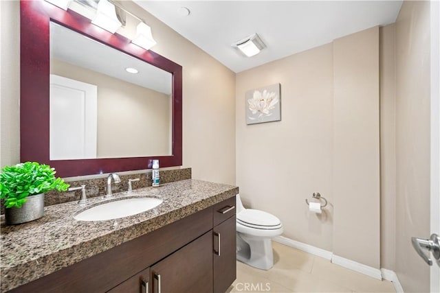 bathroom with tile patterned floors, vanity, and toilet